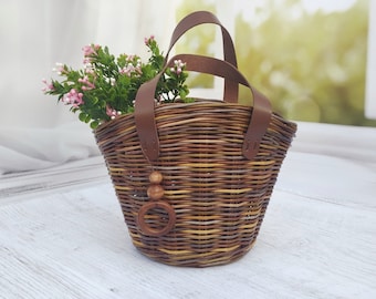 Wicker children's basket-bag for walking. Bag for a little girl.Girl's basket with flowers. A bag for toys on a walk.