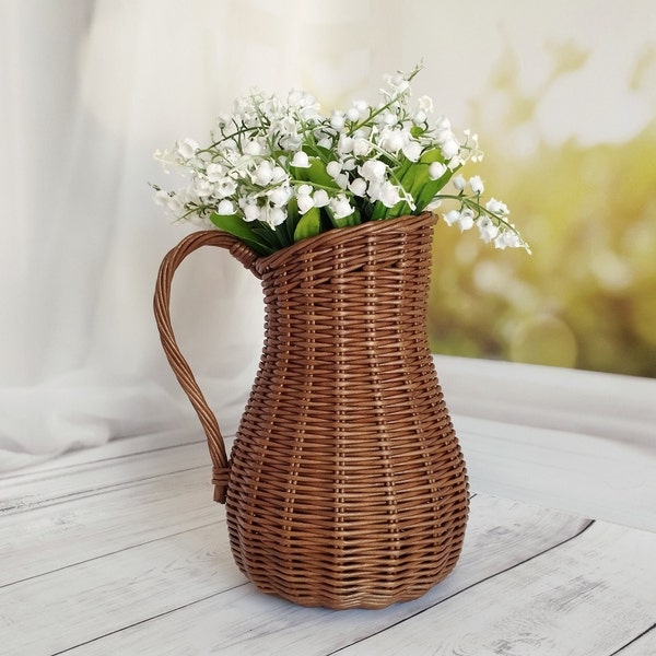 Wicker vase for flowers. Basket for artificial flowers or dried flowers. Decorative jug for home decoration. Photo props for home.