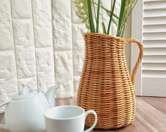 Wicker vase for flowers. Basket for artificial or dried flowers. Decorative jug for home decoration.