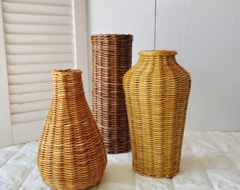 Wicker vase for flowers. Basket for artificial or dried flowers. Decorative jug for home decoration.