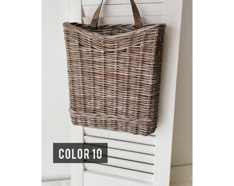 Basket on the door for flowers. Rectangular flat flower basket. Wicker basket in natural color, front door decoration. Hanging basket .