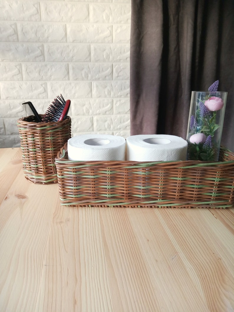 Set of two bathroom baskets. A wicker rectangular basket for toilet paper and a small round one for small items. Toilet paper holder. 11