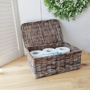 Rectangular toilet paper bin with lid in the bathroom. Storage basket.