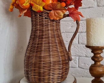 Wicker vase for flowers. Basket for artificial flowers or dried flowers. Decorative jug for home decoration. Photo props for home.