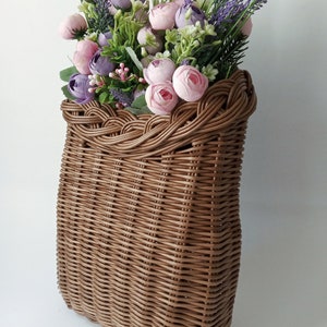 Basket on the door. Rounded flower basket. Wicker basket of motley color, decoration of the front door. Hanging basket on the door. image 6