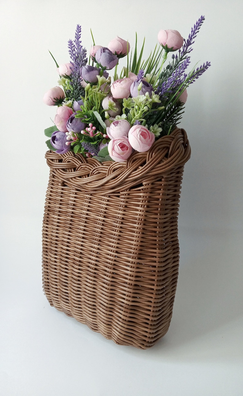 Basket on the door. Rounded flower basket. Wicker basket of motley color, decoration of the front door. Hanging basket on the door. image 6