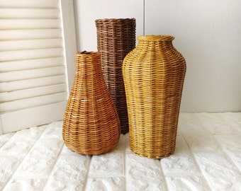 A set of three wicker vases in different shapes for dried flowers and artificial flowers. Vases for home decor.