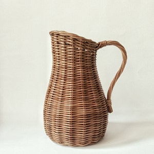 Wicker vase for flowers. Basket for artificial flowers or dried flowers. Decorative jug for home decoration. Photo props for home.