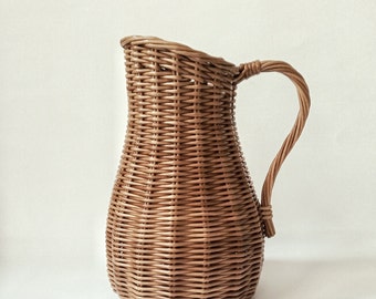 Wicker vase for flowers. Basket for artificial flowers or dried flowers. Decorative jug for home decoration. Photo props for home.