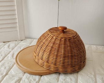 Round board with wicker lid. Wooden serving board with wicker lid. Storing food in the kitchen.