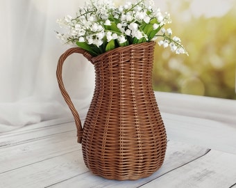 Wicker vase for flowers. Basket for artificial flowers or dried flowers. Decorative jug for home decoration. Photo props for home.