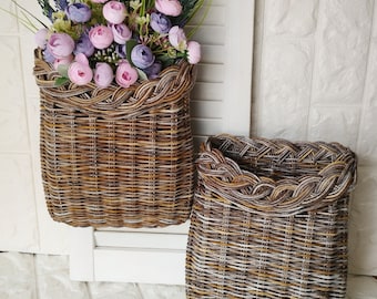 Basket on the door. Rounded flower basket. Wicker basket of motley color, decoration of the front door. Hanging basket on the door.