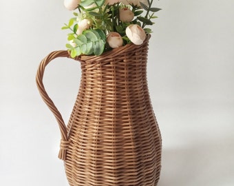 Wicker vase for flowers. Basket for artificial flowers or dried flowers. Decorative jug for home decoration. Photo props for home.