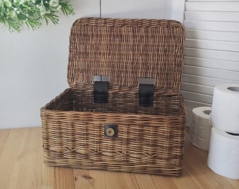Brown rectangular toilet paper basket with lid in the bathroom.