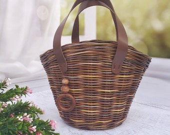 Wicker children's basket-bag for walking. Bag for a little girl.Girl's basket with flowers. A bag for toys on a walk.