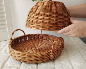 Wicker basket for beautiful serving and storage of bread.Round tray with lid for serving and storing food. Kitchen table setting.