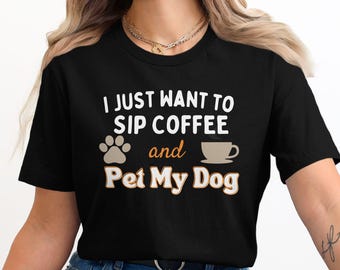 May include: Black t-shirt with the text "I just want to sip coffee and pet my dog" in white. A brown paw print and a brown coffee cup are also on the shirt.