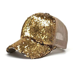 May include: A gold sequined baseball cap with a mesh back.