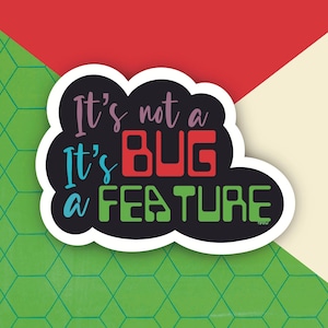 May include: A black and white sticker with a cloud shape. The text on the sticker reads "It's not a bug, it's a feature". The text is in different colors, including red, green, blue, and purple.
