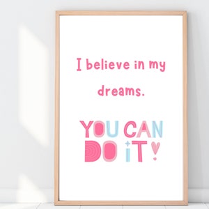 May include: A pink and blue motivational quote poster with the text "I believe in my dreams. You can do it!"