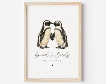 May include: A framed print featuring two watercolor penguins touching beaks. The penguins are black and white with tan feet. The print includes the names "Daniel & Emily", the date "17.02.2024", and a small heart symbol.