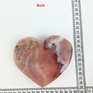 May include: A heart-shaped pink and white agate stone with a rough, natural texture. The stone is approximately 7 inches wide and 6 inches tall.