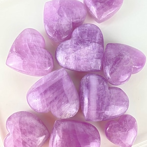 May include: A collection of ten heart-shaped polished selenite crystals in various shades of purple.