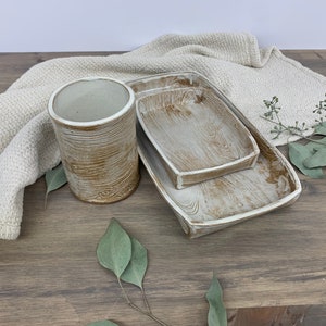 two wood-patterned trays and cup sitting on table