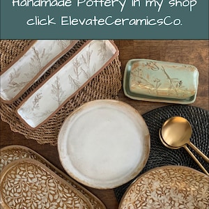 May include: Handmade pottery in various shapes and sizes, including rectangular trays, a butter dish, plates, and serving platters. The pottery features leaf and branch designs, with a neutral color palette. The image includes the text: "Find more Handmade Pottery in my shop click ElevateCeramicsCo."