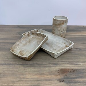 two wood-patterned trays and cup sitting on table