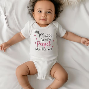 May include: White baby onesie with black text that reads "My Massi Says I'm Perfect (Just like her)" in pink.