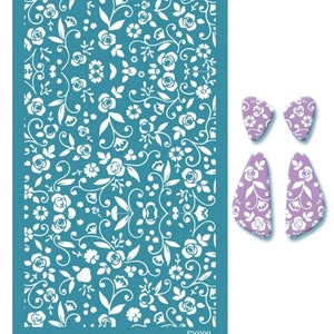May include: A turquoise blue stencil with a white floral pattern. The stencil is rectangular and has a white border. There are two smaller stencils with the same floral pattern in a light purple color.