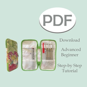 May include: A floral patterned pencil case, partially open, revealing pens, a ruler, and a red pen. The case is green with a white interior. Text on the image reads "PDF Download Advanced Beginner Step-by-Step Tutorial."