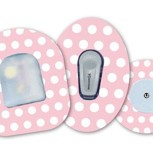 May include: Three pink and white polka dot adhesive patches for a medical device. The patches feature a clear plastic cover, a small blue device with the text "Dexcom G6", and a small blue disc with a black dot in the centre.