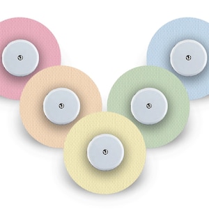 May include: Five round adhesive patches in different colors: pink, peach, light green, yellow, and light blue. Each patch has a small white circle in the center.