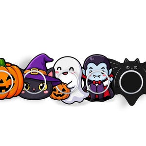 May include: A set of five Halloween-themed phone grips featuring a bright orange jack-o'-lantern, a black cat in a purple witch hat, a white ghost holding a small pumpkin, a vampire in a black cape, and a black bat with wide wings.