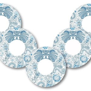 May include: Five white round stickers with a blue paisley pattern and a white circle in the centre. The stickers are arranged in a V shape.