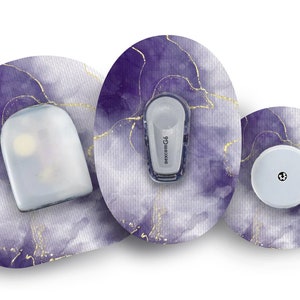 May include: Three round medical patches with a purple and gold marbled design. The patches have a white, round sensor in the center. The middle patch has a small white device with the text "dexcom G6" printed on it.