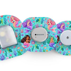 May include: Three medical device accessories with a mermaid design. The accessories have a light blue background with illustrations of mermaids, fish, and aquatic plants. The devices include a white sensor and a white receiver.
