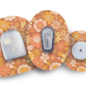 May include: A set of medical devices with a floral pattern in shades of orange, yellow, and white. The devices include a sensor, a transmitter labeled "dexcom G6", and a receiver. The floral pattern is on the adhesive patches.