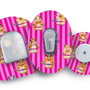 May include: Three adhesive patches with a bright pink and white vertical striped pattern featuring illustrations of hamsters playing with hula hoops. The patches are applied to medical devices, including a Dexcom G6 transmitter and a circular sensor.