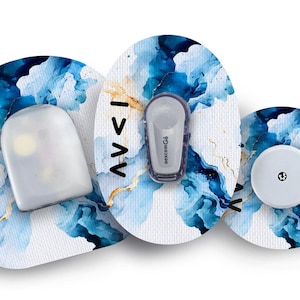 May include: Three round medical patches with a blue and white watercolour design. The patches have the text "12/1" on them. One patch has a small white sensor with a black dot in the centre. Another patch has a small white sensor with a black dot in the centre and a small white device with the text "FreeStyle Libre" on it. The third patch has a small white device with a black dot in the centre.