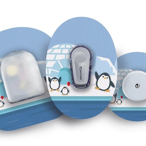 May include: Three different designs for a medical device patch. Each patch features a blue and white background with a cartoon penguin design. The text "FreeStyle Libre" is visible on one of the patches.