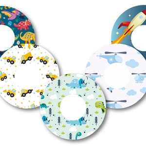 May include: Five colorful round stickers with different designs. The stickers feature dinosaurs, construction vehicles, helicopters, a rocket ship, and a moon. The stickers are perfect for adding a fun touch to any project.