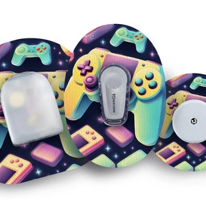 May include: A set of three round adhesive patches with a retro video game theme. The patches feature a dark blue background with colourful pixelated game controllers, stars, and game consoles. The patches are designed to cover a medical device.
