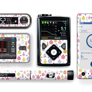 May include: A set of colorful Christmas ornament themed skins for a blood glucose meter, insulin pump, and insulin pen. The skins feature a white background with a repeating pattern of colorful ornaments and hearts.