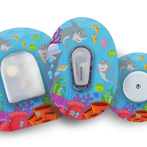 May include: Medical devices with an underwater design. The blue background features cartoon sharks, seahorses, and coral reefs. The set includes a sensor, a transmitter, and a receiver.