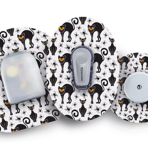 May include: Three round adhesive patches with a Halloween-themed design featuring black cats and spiders. The patches are white with black and orange accents. The text "dexcom G6" is visible on one of the patches.