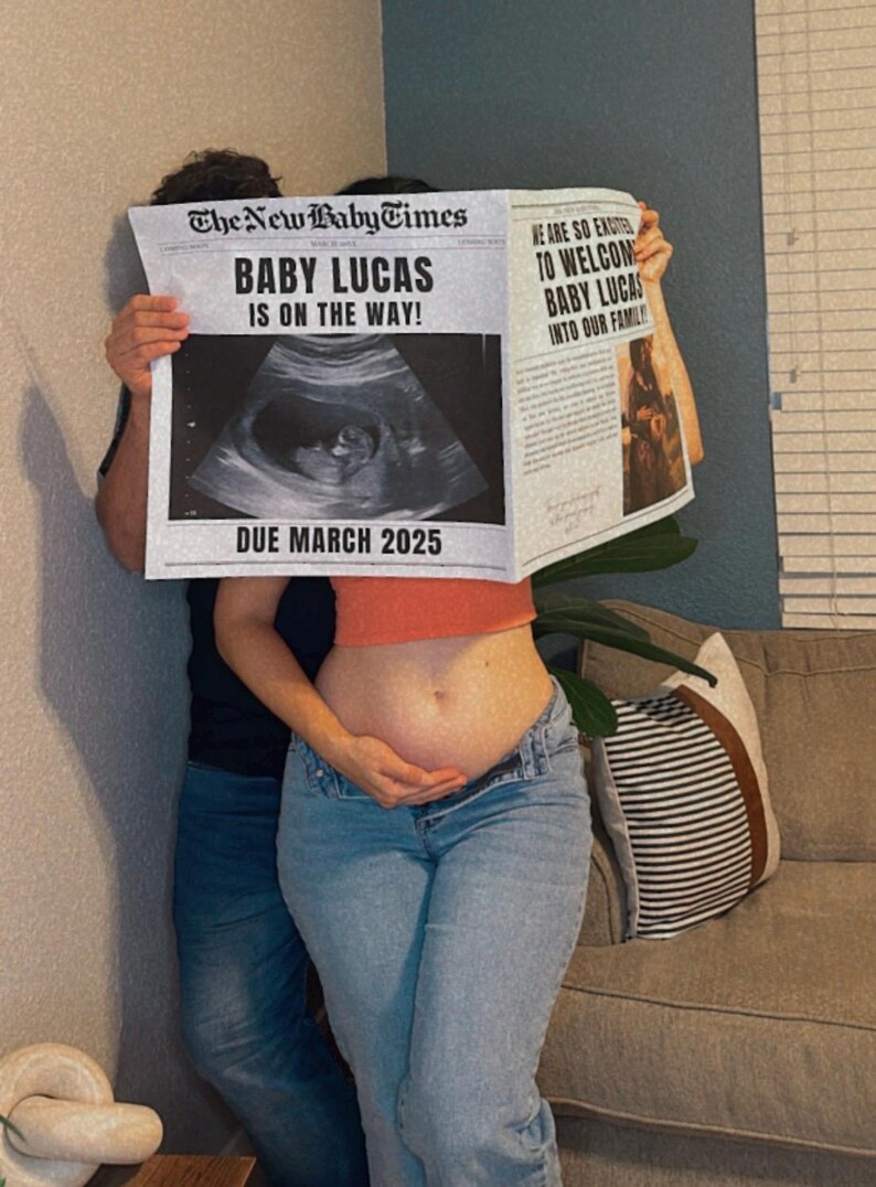May include: A couple holds up a newspaper announcing the pregnancy of "Baby Lucas" with a due date of March 2025. The newspaper features an ultrasound image and the headline "Baby Lucas is on the way!"