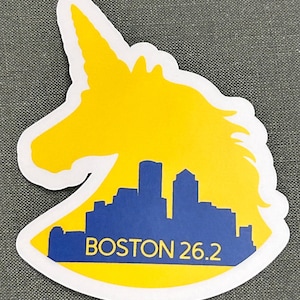 May include: Yellow unicorn silhouette sticker with a blue cityscape inside and the text "BOSTON 26.2".